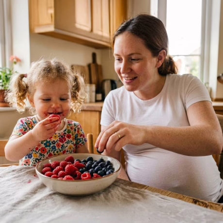Mother and daughter eating strawberries